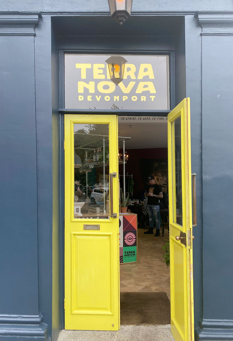 Photo of the bright yellow front door of the Terra Nova cafe