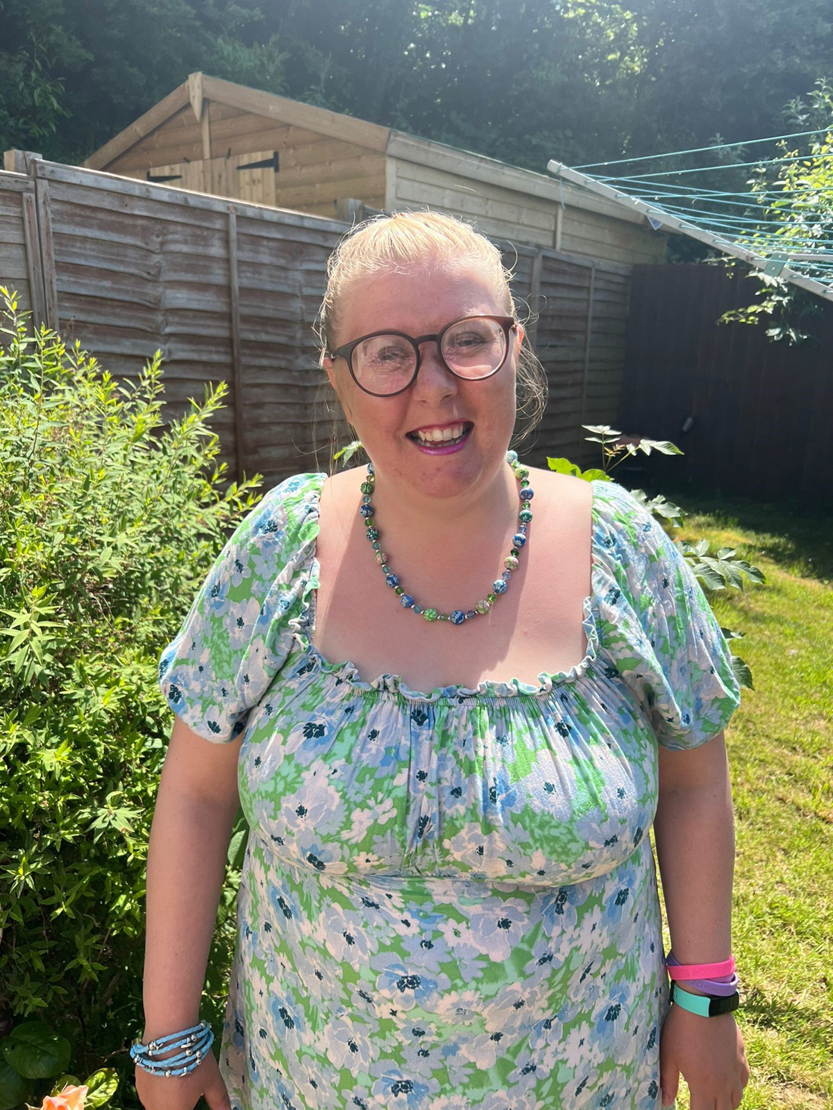 Photo of Chantelle, a woman in a summer dress standing in the garden.