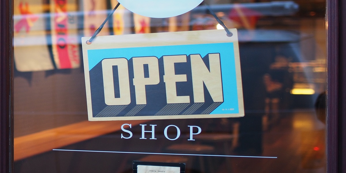 Sign in a shop window that says open